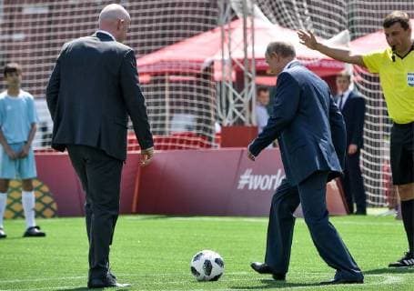 MOSCOW, RUSSIA - JUNE 28, 2018: FIFA President Gianni Infantino (L) looks on as Russia s President Vladimir Putin kicks the ball (R) as they visit the 2018 FIFA World Cup Football Park in Red Square. Alexei Nikolsky Russian Presidential Press and Information Office TASS  TS086D76