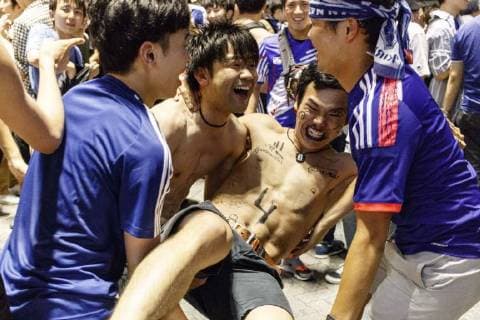 June 29, 2018 - Tokyo, Japan - Japanese soccer fans celebrate in Shibuya after their team advanced to the second round of World Cup in Tokyo, Japan. Japan s Soccer National Team. Japan sealed their position to the second round of the FIFA World Cup despite losing to Poland 1-0 in Volgograd Arena in Volgograd, Russia. Soccer fans who watched the game in Tokyo gathered in Shibuya s famous scramble crossing to celebrate, the Tokyo Metropolitan Police were on hand to control access. Tokyo Japan - ZUMAm191 20180629_zap_m191_013 Copyright: xRodrigoxReyesxMarinx