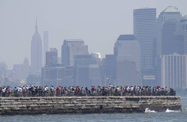Tourists stand on Liberty Island with a view of The Statue of Liberty and Manhatan 2 days before Independence Day and the 4th of July in New York City on July 2, 2018.  NYP20180702105 JOHNxANGELILLO