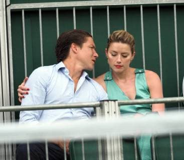 LONDON, ENGLAND - JULY 07: it s official THEY HAVE THEIR FIRST KISS Amber Heard wearing a low cut mint jumpsuit with new boyfriend Vito Schnabel attend day seven of the Wimbledon Tennis Championships at the All England Lawn Tennis and Croquet Club on July 7, 2018 in London, England..People: Vito Schnabel and Amber Heard London England - ZUMAs214 20180709_zba_s214_075 Copyright: xSMGx