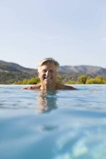 Senior man relaxing in pool, portrait  Copyright: AntoinexArraou B96681013