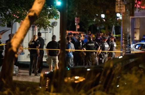 (180723) -- TORONTO, July 23, 2018 -- Police officers gather at the crime scene in Toronto, Canada, on July 23, 2018. A man shot 14 people, killing one and injuring 13 others in Toronto s east-end neighborhood before dying after an exchange of gunfire with police, according to CTV Monday. ) (dtf) CANADA-TORONTO-SHOOTING LixHaitao 