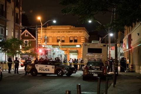 (180723) -- TORONTO, July 23, 2018 -- Police officers gather at the crime scene in Toronto, Canada, on July 23, 2018. A man shot 14 people, killing one and injuring 13 others in Toronto s east-end neighborhood before dying after an exchange of gunfire with police, according to CTV Monday. ) (dtf) CANADA-TORONTO-SHOOTING LixHaitao 