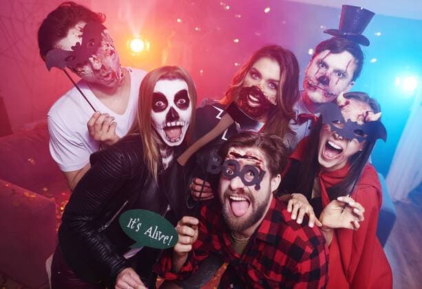 Friends in creepy costumes having fun at Halloween party model released Symbolfoto property released  ABIF00512