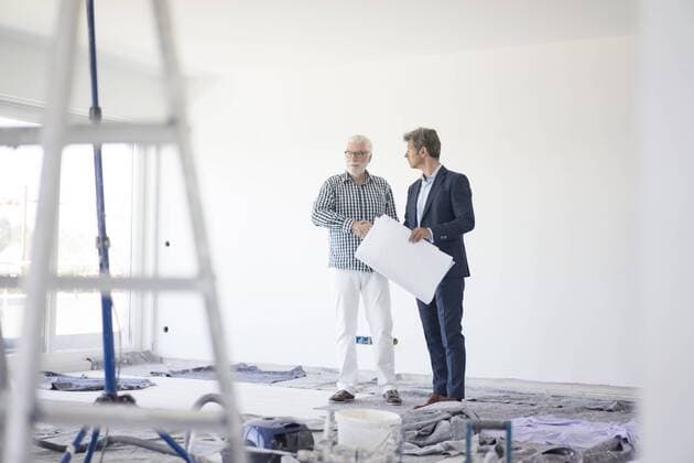 Man in suit and senior man talking on room under construction model released Symbolfoto property released  MOEF01285