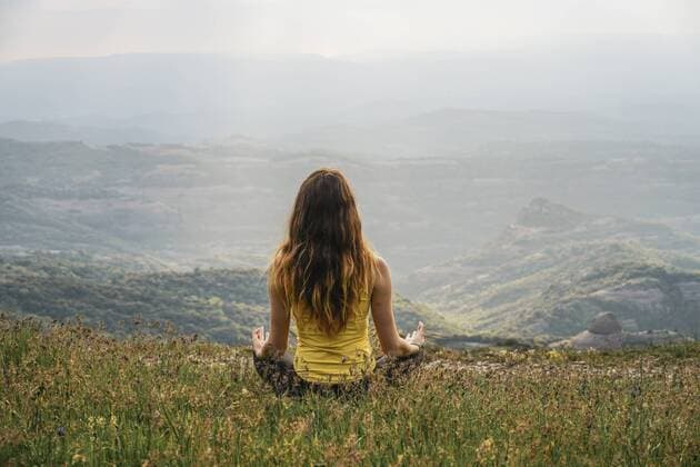 Spain, Barcelona, back view of young woman practising yoga on Montcau Mountain model released Symbolfoto  AFVF00540