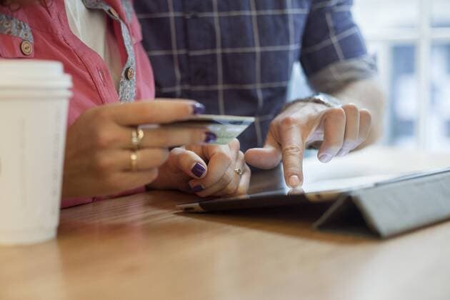 Couple shopping online using digital tablet  Copyright: GabrielxSanchez B25216137