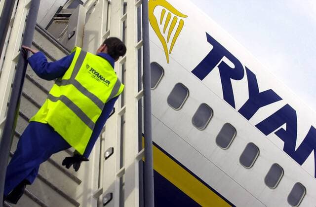 BRU25 - - CHARLEROI, BELGIUM : Illustration picture shows worker geting inside a plane of Ryanair low cost airline company, in Brussels South Airport, in Charleroi, as European commission decided this Tuesday 03 February 2004 that Ryanair has to repay a part of the subsidy of the Walloon government. VIRGINIExLEFOUR  x1552984x