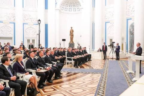 MOSCOW, RUSSIA â€“ JULY 28, 2018: Russia s President Vladimir Putin (R) at a ceremony to present state decorations and certificates of merit to Russian men s national football team players and coaches following the 2018 FIFA World Cup at the Moscow Kremlin. Mikhail Klimentyev Russian Presidential Press and Information Office TASS  TS08B0DF