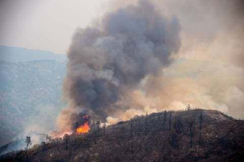 August 6, 2018 - Lake County, California, U.S. - A hot spot flares in the afternoon along High Valley Road during the Ranch Fire on Monday. The Mendocino Complex Fire is the second-largest wildfire in the state’s history. Lake County U.S. - ZUMAs76_ 20180806_zaf_s76_004 Copyright: xPaulxKitagakixJrx