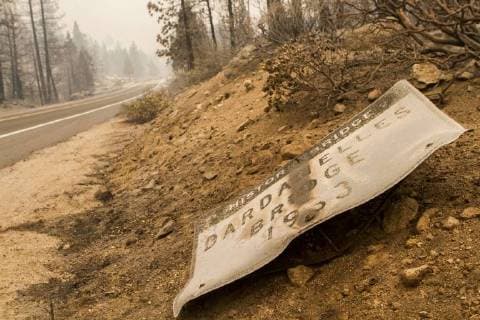 August 6, 2018 - Dardnelle, California, U.S.A - The Dardanelles Historic bridge sign was brought to the ground along with the historic bridge as fire damaged both Monday, Aug. 6, 2018. The Donnell Fire in Tuolumne County has grown to 11,074 Acres according to the U.S. Forest Service. Dardnelle U.S.A - ZUMAbk2_ 20180806_zaf_bk2_019 Copyright: xMartyxBicekx