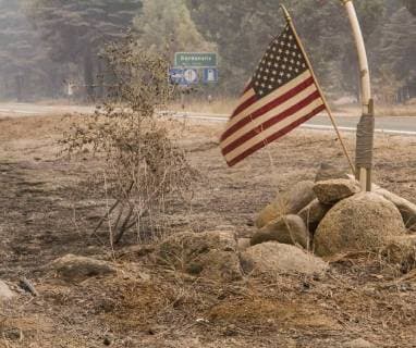 August 6, 2018 - Dardnelle, California, U.S. - Not much around the Daranelles are was still standing but this American flag was one of them Monday. The Donnell Fire in Tuolumne County has grown to 11,074 Acres according to the U.S. Forest Service. Dardnelle U.S. - ZUMAbk2_ 20180806_zaf_bk2_004 Copyright: xMartyxBicekx