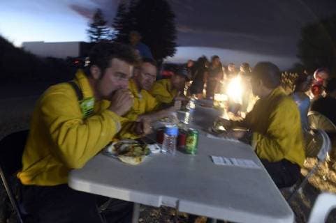 August 6, 2018 - Ukiah, California, USA - Ukiah, California, U.S. - Members of the Culver City Fire Department enjoy a meal provided by a taco truck parked outside the Mendocino Complex Incident Command Post. Ukiah USA - ZUMAw332 20180806_zap_w332_011 Copyright: xNealxWatersx