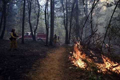 August 7, 2018 - Ukiah, California, USA - Ukiah, California, U.S. - The Rancho Adobe Fire District engine crew help to control the back fire. Ukiah USA - ZUMAw332 20180807_zap_w332_008 Copyright: xNealxWatersx