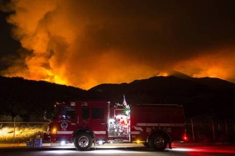 August 7, 2018 - Dallas, California, United States - August 7, 2018 - Corona, CA - Riverside County Fire Department keeps watch over the night, as the Holy Jim Trailhead fire illuminates the night sky. Dallas United States - ZUMAr164 20180807_zap_r164_003 Copyright: xChrisxRusanowskyx