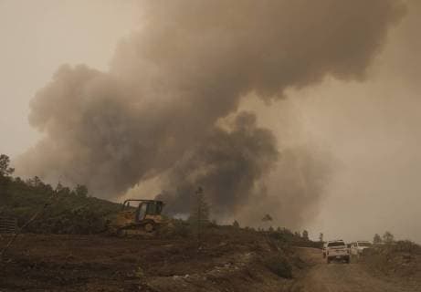 CalFire personnel use a bulldozer to create a fire break along a ridge in Colusa County, California on August 7, 2018. The Mendocino Complex fire has become the largest in the state s history.  SXP2018080704 TERRYxSCHMITT