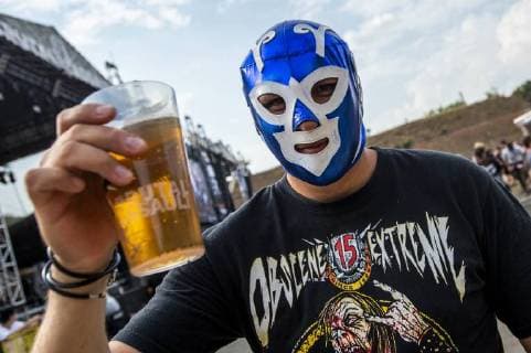 A fan with mask holds a beer as the heavy metal festival Brutal Assault in the fort Josefov in Jaromer, Nachod district, Czech Republic, starts on Wednesday, August 8, 2018. About hundred thirty bands will perform during four days of the festival. (CTKxPhoto DavidxTanecek) CTKPhotoP201808080873101  TAD 010