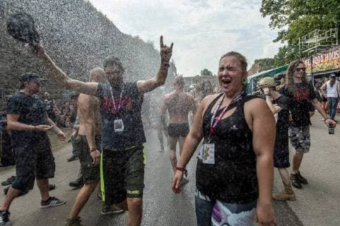 Fans cool themselves as the heavy metal festival Brutal Assault in the fort Josefov in Jaromer, Nachod district, Czech Republic, starts on Wednesday, August 8, 2018. About hundred thirty bands will perform during four days of the festival. (CTKxPhoto DavidxTanecek) CTKPhotoP201808080873601  TAD 013