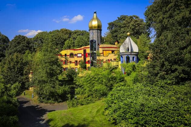 31 08 2016 Essen Nordrhein Westfalen Ruhrgebiet Germany Grugapark Parkland of the Federal Horticultural Show 1965 Ronald McDonald House Eating the Hundertwasser House in the Grugapark on the occasion of the Essen 2017 Green Capital of Europe Essen Nordrhein Westfalen Germany