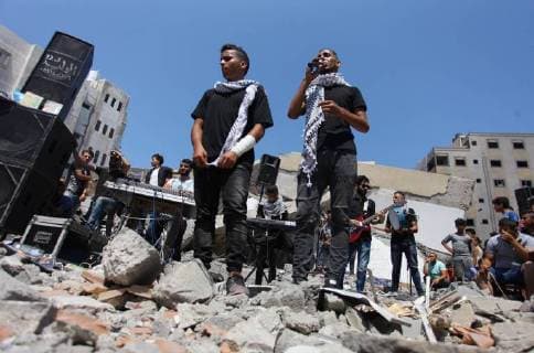 August 10, 2018 - Gaza City, Gaza Strip, Palestinian Territory - Members of a Palestinian musical band perform on the rubble of Said al-Mishal Cultural Center following an Israeli air strike destroyed it on the previous day, in Gaza city on Aug. 10, 2018 Gaza City Palestinian Territory - ZUMAap3_ 20180810_zaf_ap3_020 Copyright: xMahmoudxAjourx