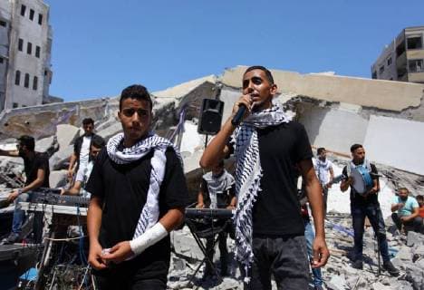 August 10, 2018 - Gaza City, Gaza Strip, Palestinian Territory - Members of a Palestinian musical band perform on the rubble of Said al-Mishal Cultural Center following an Israeli air strike destroyed it on the previous day, in Gaza city on Aug. 10, 2018 Gaza City Palestinian Territory - ZUMAap3_ 20180810_zaf_ap3_022 Copyright: xMahmoudxAjourx