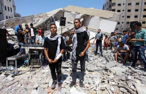 August 10, 2018 - Gaza City, Gaza Strip, Palestinian Territory - Members of a Palestinian musical band perform on the rubble of Said al-Mishal Cultural Center following an Israeli air strike destroyed it on the previous day, in Gaza city on Aug. 10, 2018 Gaza City Palestinian Territory - ZUMAap3_ 20180810_zaf_ap3_005 Copyright: xMahmoudxAjourx