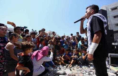 August 10, 2018 - Gaza City, Gaza Strip, Palestinian Territory - Members of a Palestinian musical band perform on the rubble of Said al-Mishal Cultural Center following an Israeli air strike destroyed it on the previous day, in Gaza city on Aug. 10, 2018 Gaza City Palestinian Territory - ZUMAap3_ 20180810_zaf_ap3_001 Copyright: xMahmoudxAjourx