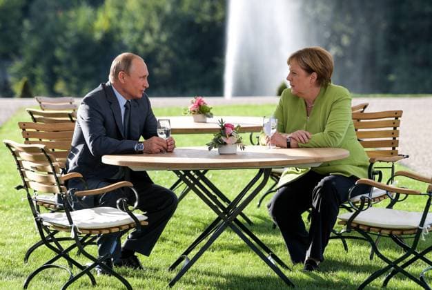 GRANSEE, GERMANY - AUGUST 18, 2018: Russia s President Vladimir Putin (L) and German Chancellor Angela Merkel meet at a reception house at Schloss Meseberg. Alexei Druzhinin Russian Presidential Press and Information Office TASS  TS08D326
