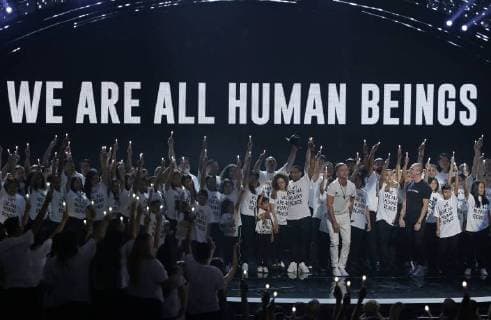 Logic is backed by children wearing We are all human beings shirts during the 35th annual MTV Video Music Awards at Radio City Music Hall in New York City on August 20, 2018.  NYP20180820115 JOHNxANGELILLO
