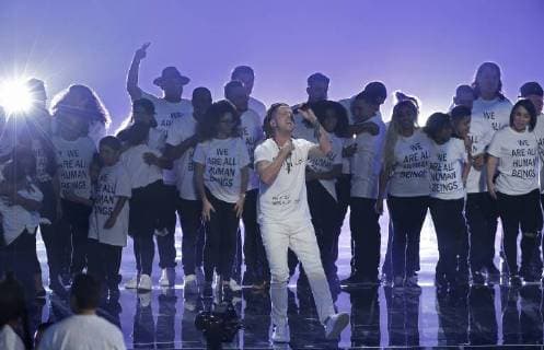 Logic is backed by children wearing We are all human beings shirts during the 35th annual MTV Video Music Awards at Radio City Music Hall in New York City on August 20, 2018.  NYP20180820114 JOHNxANGELILLO