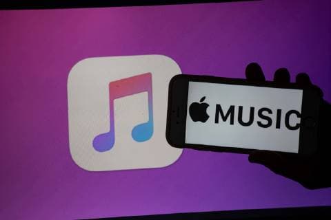 August 21, 2018 - Munich, Bavaria, Germany - The logo of the music streaming app Apple Music is seen on a mobile screen and a laptop screen. The numbers of people using music streaming apps grow. The biggest one is the Swedish Spotify with 83 million paying users and about 100 others, that use the free version. Munich Germany  - ZUMAn230 20180821_zaa_n230_212 Copyright: xAlexanderxPohlx