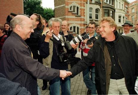 Former bishop of Evreux, Jacques Gaillot, left, shakes hands with European Deputy, Daniel Cohn-Bendit, during an action to boycott all Total-Fina filling station, who support the military dictature in Birmania. Thursday May 20, 1999, in Brussels. Belga Photo Jacques Collet JACQUESxCOLLET  x361248x