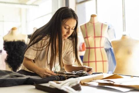 Young fashion designer working in her studio model released Symbolfoto property released  AFVF00749