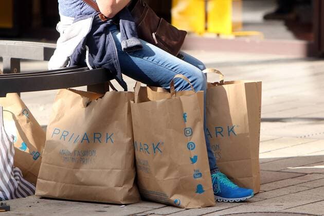 Woman with paper bags of cheap fashion chain Primark in downtown Mannheim Baden-Württemberg Germany