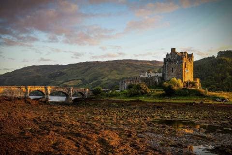 Eilean Donan Castle Eilean Donan Castle is a lowland castle near Dornie a small village in Scotland Eilean Donan Castle is located at Loch Duich in the western Scottish Highlands The castle is situated on a small promontory which becomes a tiny tidal island at high tide The castle is the ancestral seat of the Macrae Scottish clan Copyrig