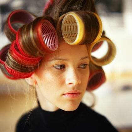 Young woman with rollers in hair  Copyright: PatrickxMacxSean B84927801