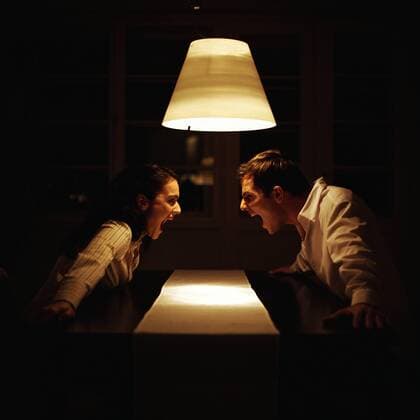 Man and woman face to face at table, screaming at each other  Copyright: PatrickxMacxSean B94621601