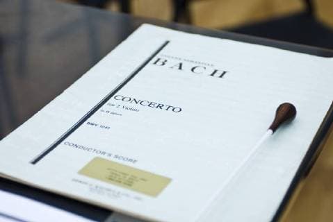 Conductors musical score with baton on stand  Copyright: MichèlexConstantini B62497506