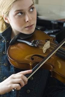 Young woman practicing violin  Copyright: MichèlexConstantini B68597606