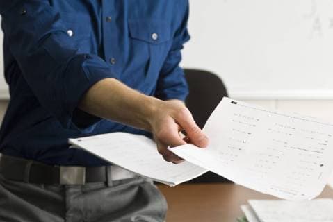 Teacher handing out classwork assignment  Copyright: MichèlexConstantini B74792306