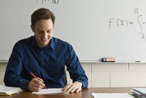 Teacher marking homework  Copyright: MichèlexConstantini B78393906