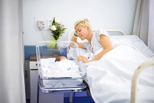 Mother lovingly looking at her newborn baby still in the hospital Copyright: imageBROKER/JacekxSopotnicki ibxjas04734533.jpg