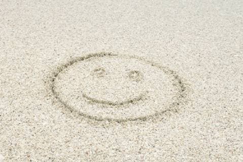 Smiley face drawn in sand at the beach  Copyright: MichèlexConstantini B53599009