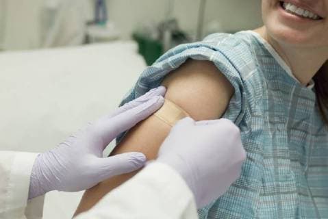 Doctor applying adhesive bandage to patient s arm  Copyright: MichèlexConstantini B87595808