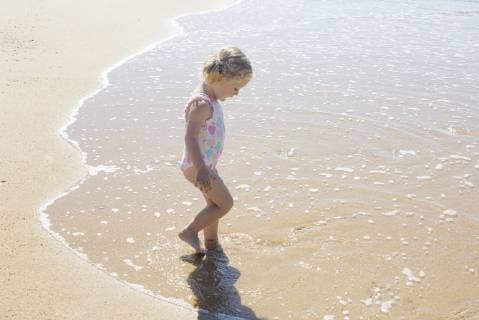 Little girl wading in the surf  Copyright: Anne-SophiexBost B78318731