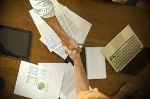 Business associates shaking hands during meeting  Copyright: FrédéricxCirou B92482825