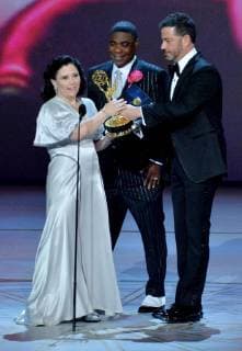 Alex Borstein (L) accepts the Outstanding Supporting Actress in a Comedy Series award for The Marvelous Mrs. Maisel from Tracy Morgan and Jimmy Kimmel (R) onstage during the 70th annual Primetime Emmy Awards at the Microsoft Theater in downtown Los Angeles on September 17, 2018.  LAP20180917599 JIMxRUYMEN