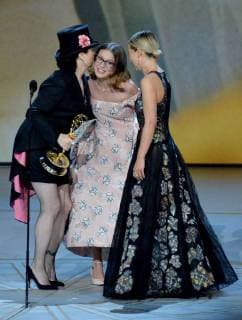 Amy Sherman-Palladino (L) accepts the Outstanding Writing for a Comedy Series award for The Marvelous Mrs. Maisel from Emilia Clarke and Millie Bobby Brown (R) onstage during the 70th annual Primetime Emmy Awards at the Microsoft Theater in downtown Los Angeles on September 17, 2018.  LAP20180917591 JIMxRUYMEN