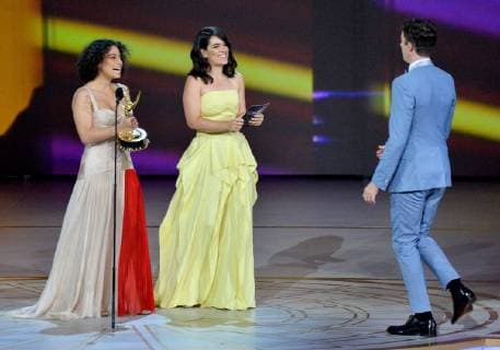 Ilana Glazer (L) and Abbi Jacobson present the award to John Mulaney onstage during the 70th annual Primetime Emmy Awards at the Microsoft Theater in downtown Los Angeles on September 17, 2018.  LAP201809171093 JIMxRUYMEN