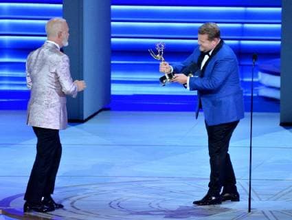 Ryan Murphy (L) accepts the Outstanding Directing for a Limited Series, Movie, or Dramatic Special award for The Assassination of Gianni Versace: American Crime Story from James Corden onstage during the 70th annual Primetime Emmy Awards at the Microsoft Theater in downtown Los Angeles on September 17, 2018.  LAP201809171118 JIMxRUYMEN